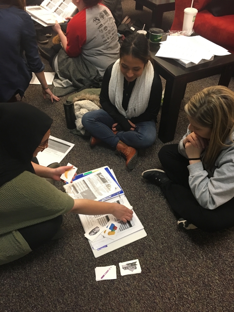 Student training with children sitting on the floor